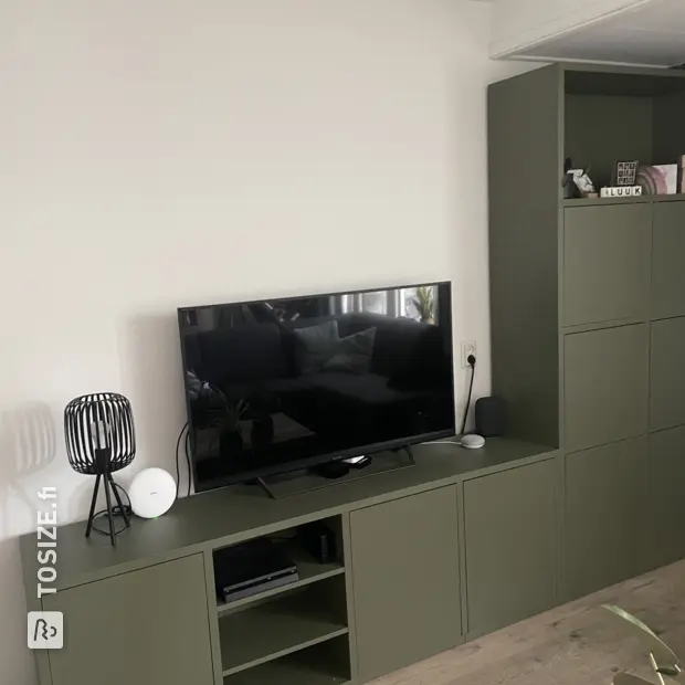 Green cabinet with doors and open compartments