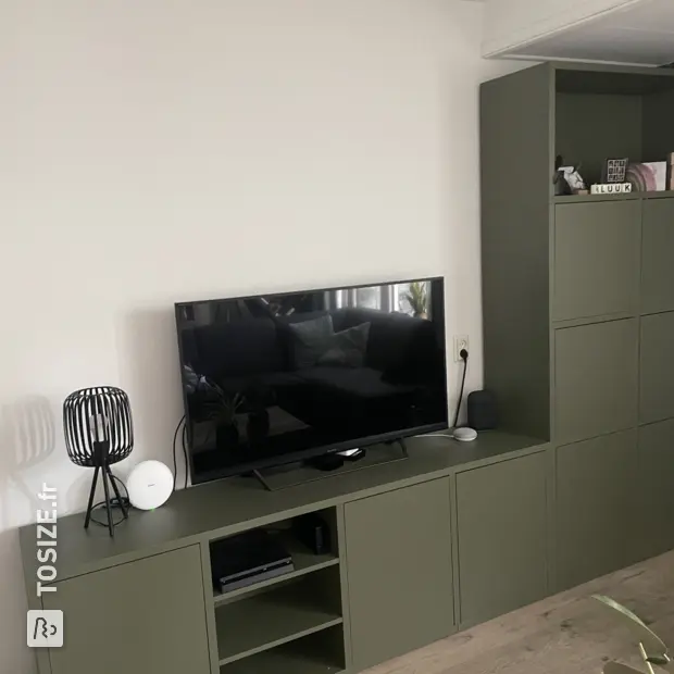 Green cabinet with doors and open compartments