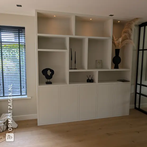 White wall unit with open compartments and doors