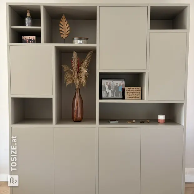 Grey wall unit with doors and open compartments