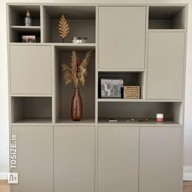 Grey wall unit with doors and open compartments