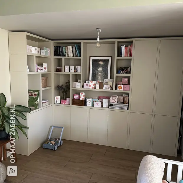 Cream wall unit with open compartments and doors