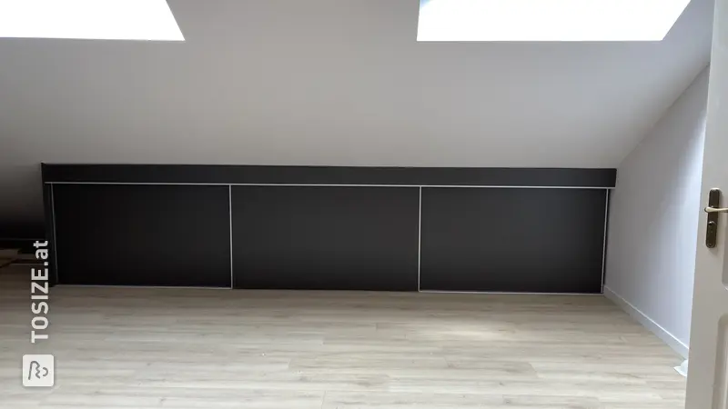 Custom-made sliding door wardrobe for a sloping wall, by Lucy