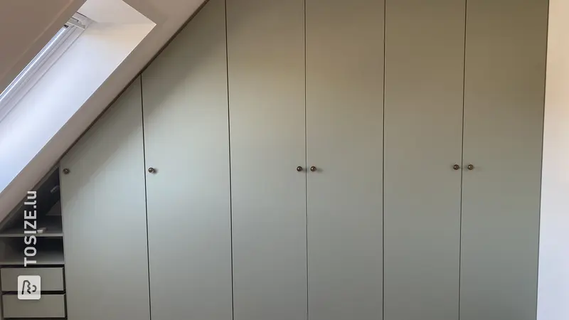 Custom-made wardrobe under a sloping roof, by Dick