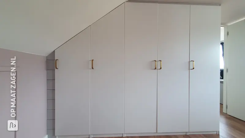 Custom-made wardrobe under a sloping roof, by Marleen