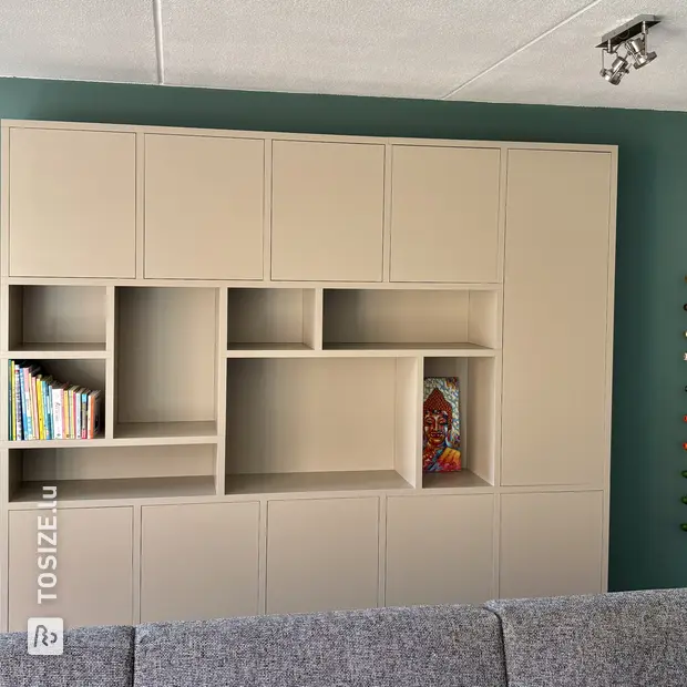 Beige wall unit with open compartments and doors
