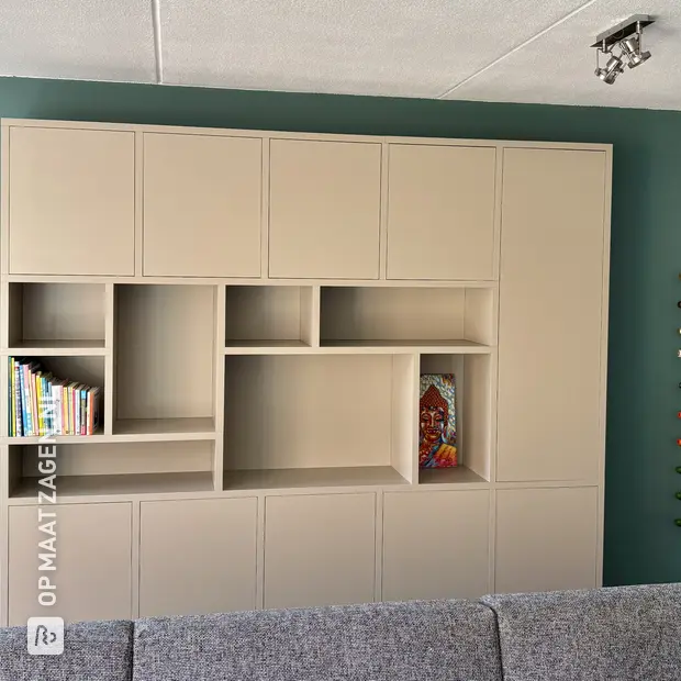 Beige wall unit with open compartments and doors