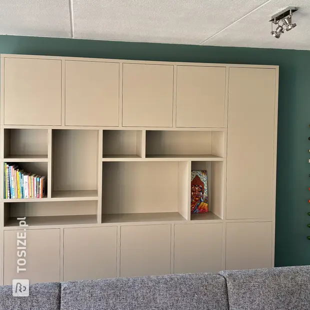 Beige wall unit with open compartments and doors