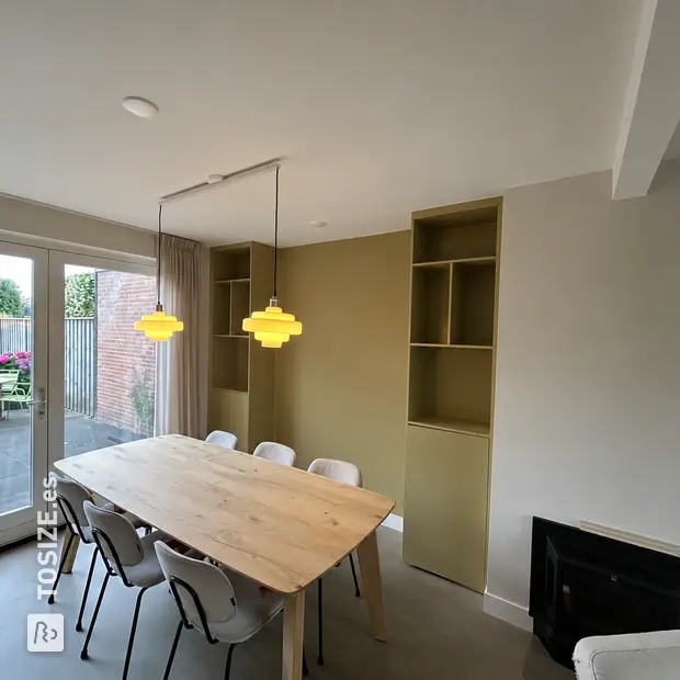 Light green cabinet with open compartments and shelves