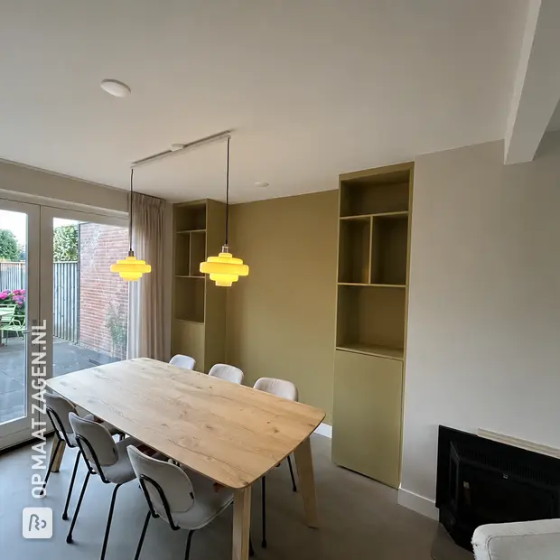Light green cabinet with open compartments and shelves