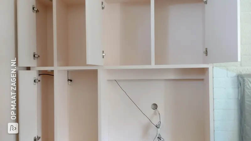 Stylish custom-made TV cabinet in an alcove, by Johan