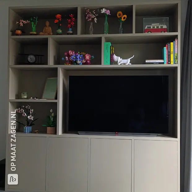 Beige wall unit with open compartments and doors
