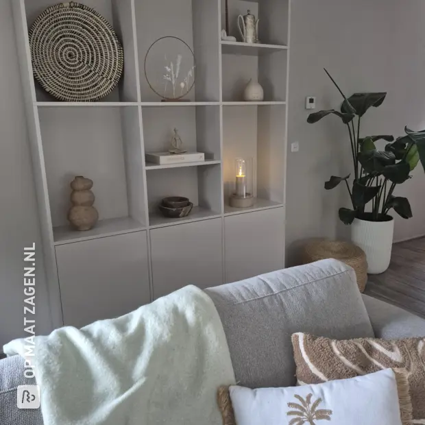 Light wood shelving unit with open compartments and doors