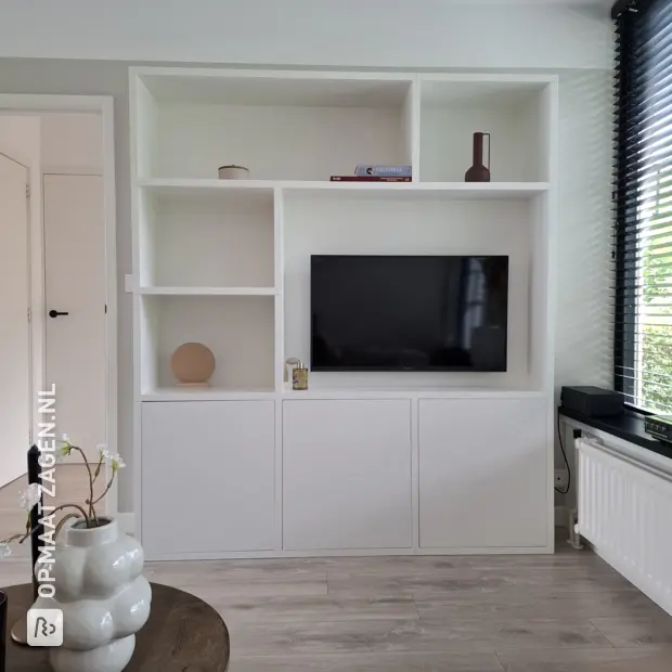 White wall unit with doors and open compartments