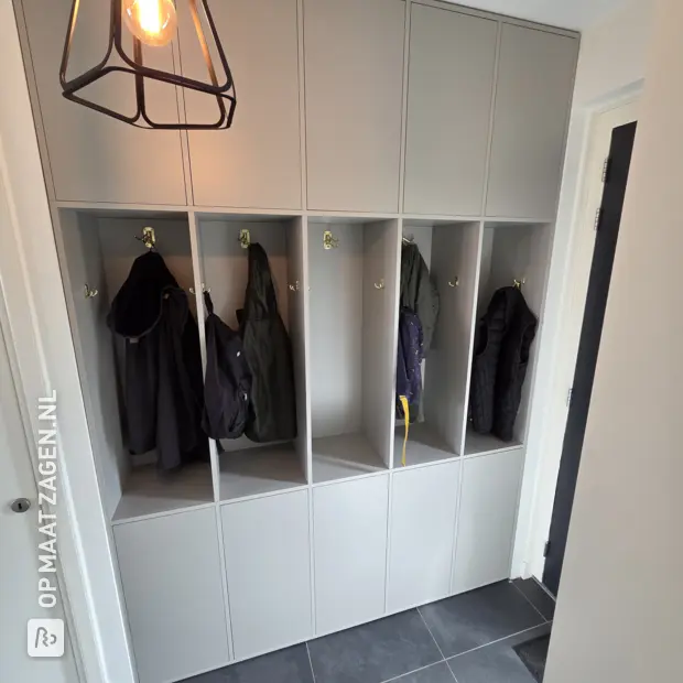 Grey shoe cabinet with open compartments and doors