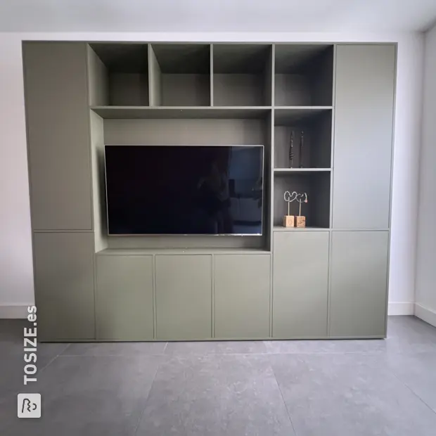 Green wall unit with open compartments and doors