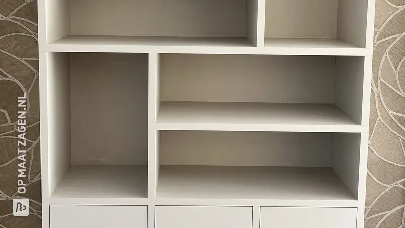 Sleek beige cabinet with wallpaper accents, by A.