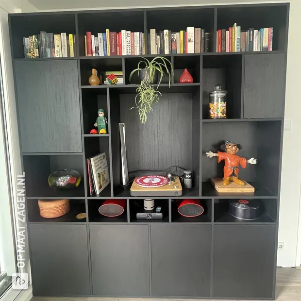 Black compartment cabinet with open compartments and doors