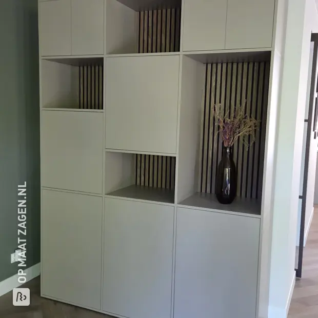 Cream wall unit with open compartments and doors