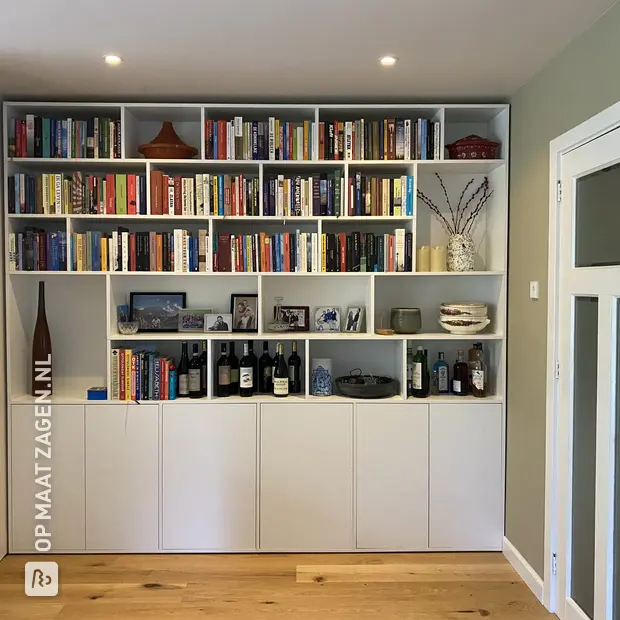 White wall unit with open compartments and shelves