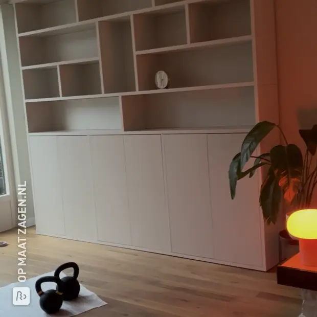 White wall unit with open compartments and doors