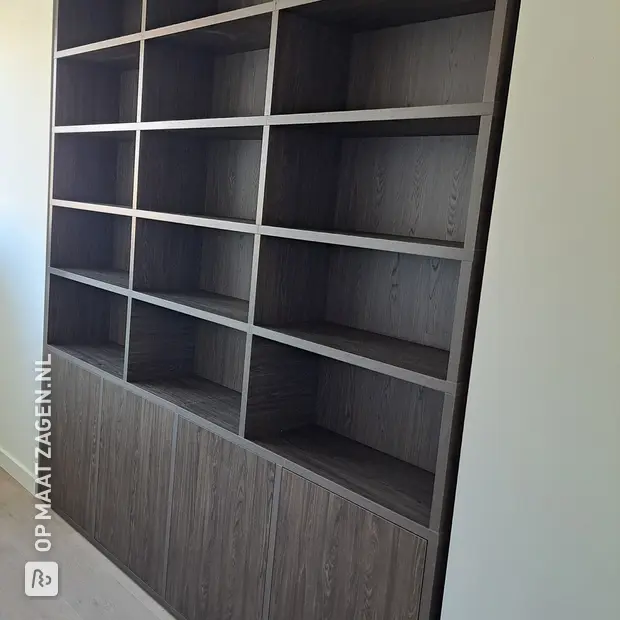 Dark wall unit with open compartments and doors