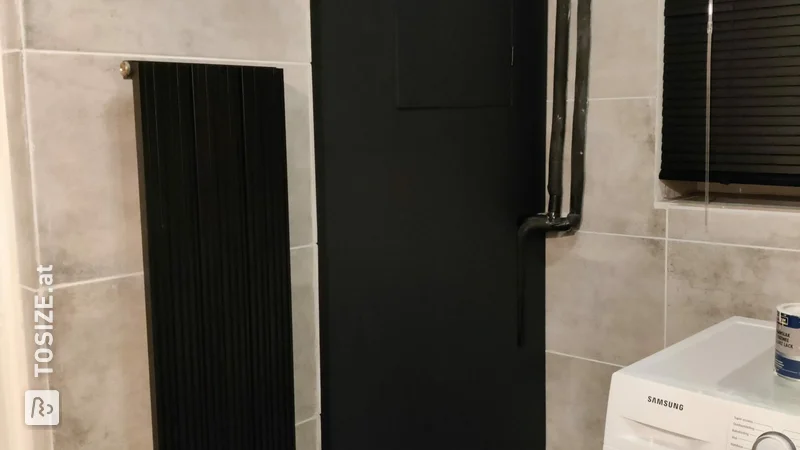 Black, industrial door for the central heating, by Denise