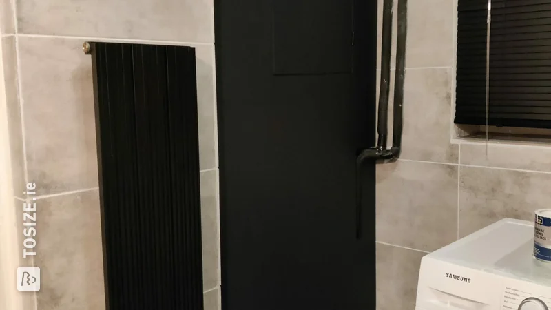 Black industrial door for the central heating, by Denise