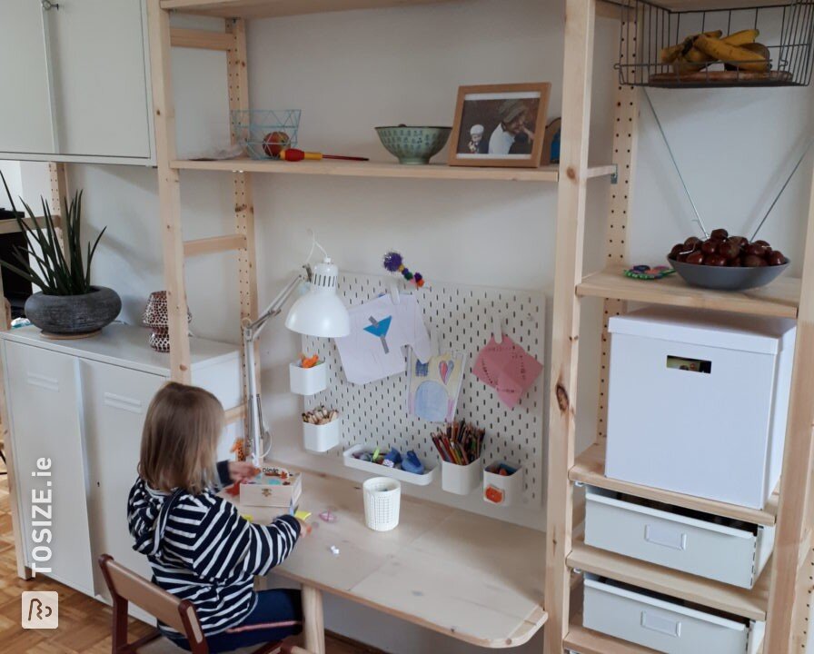 A children&#39;s desk between two cupboards