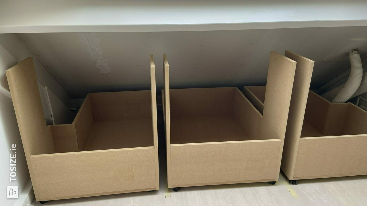 Slanted wall with storage boxes, by Dennis