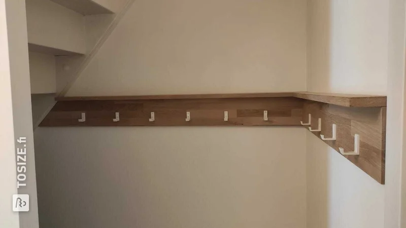 Custom oak coat rack with white hooks, by Martijn