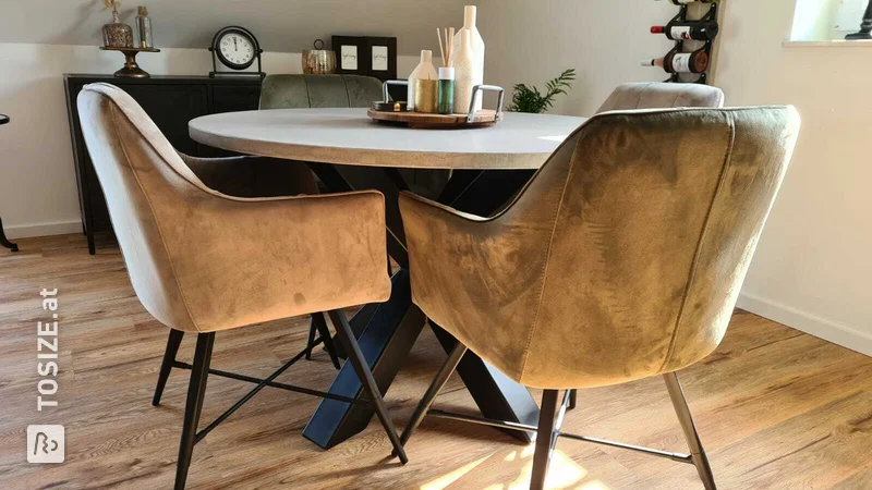 Round concrete look dining room table made of MDF, by Maarten