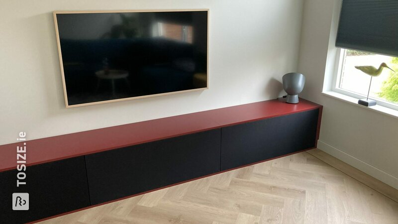 Long and sleek TV cabinet made of plywood birch finished with speaker cloth, by Derjan