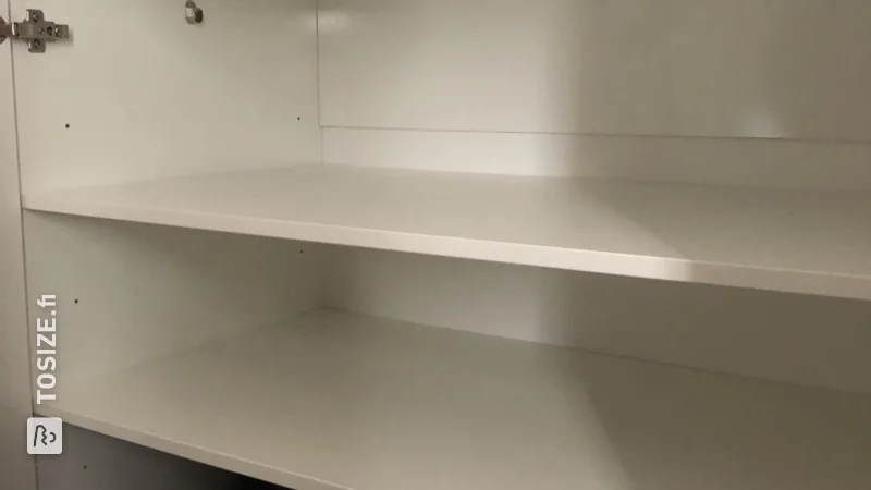 Extra cupboard space with white furniture panel shelves, by Melvin