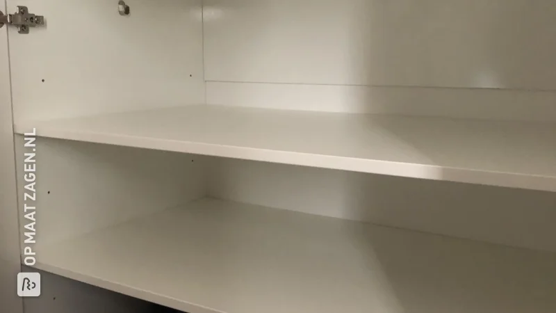 Extra cupboard space with white furniture panel shelves, by Melvin