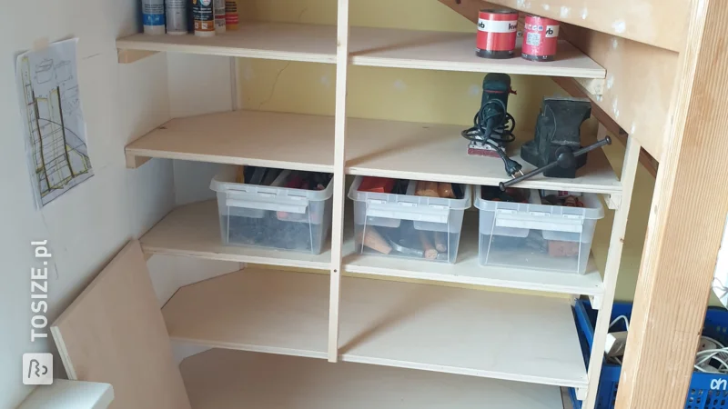 A custom tool cabinet under the stairs, by Marcel 