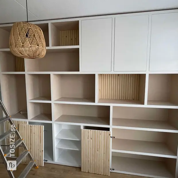 White cupboard wall with doors and open compartments