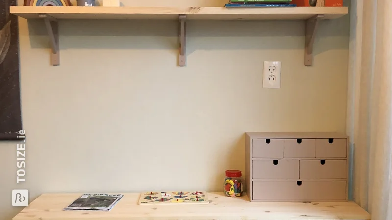 A custom children's desk with storage bins and wall shelf, by Joanne
