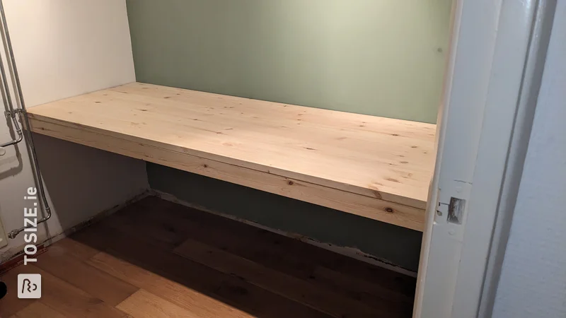 A homemade large floating desk made of pine wood carpentry panel, by Ingmar