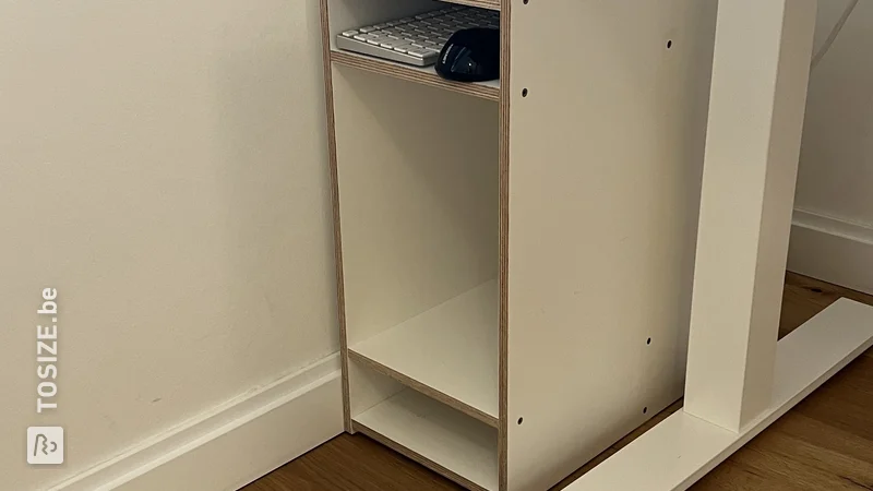 A small storage cabinet made of birch plywood for next to the desk, by Hendrik