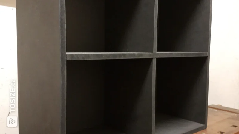 A black MDF shelf for folders and a stand for the desk, by Benjamin