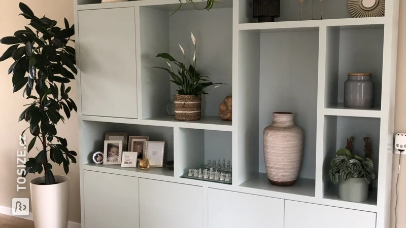 A light blue painted TOSIZE Furniture cupboard, by Marije