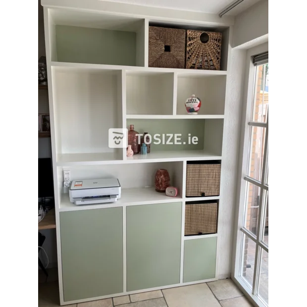 Light green cupboard wall with open compartments and doors