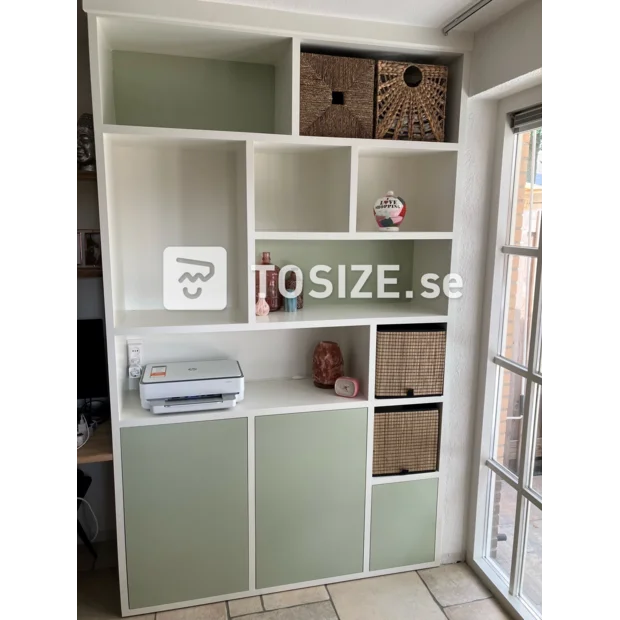 Light green cupboard wall with open compartments and doors