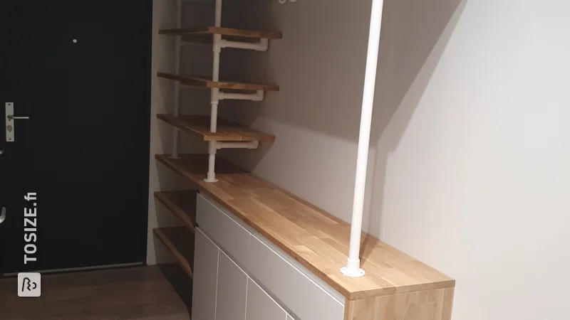 A homemade hallway cupboard with coat rack custom finished with oak carpentry panel, by Tjardo