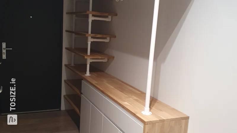 A homemade hallway cupboard with coat rack custom finished with oak carpentry panel, by Tjardo