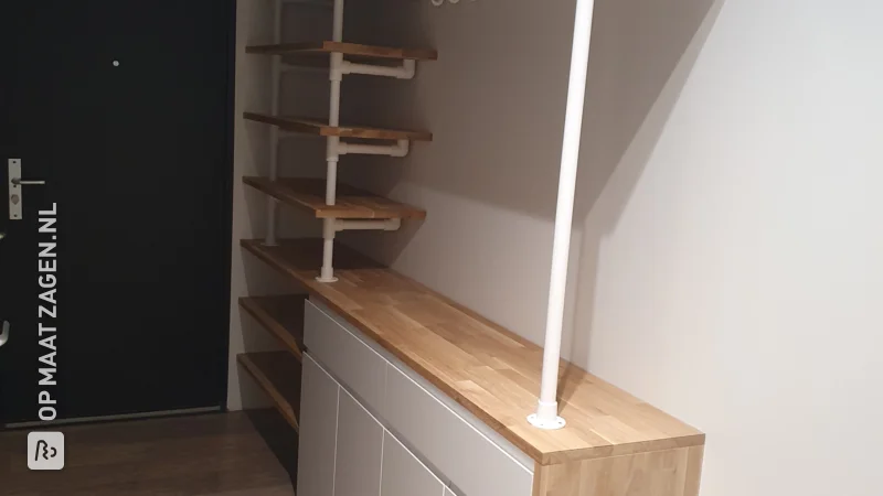 A homemade hallway cupboard with coat rack custom finished with oak carpentry panel, by Tjardo
