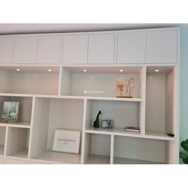 White cupboard wall with doors and open compartments