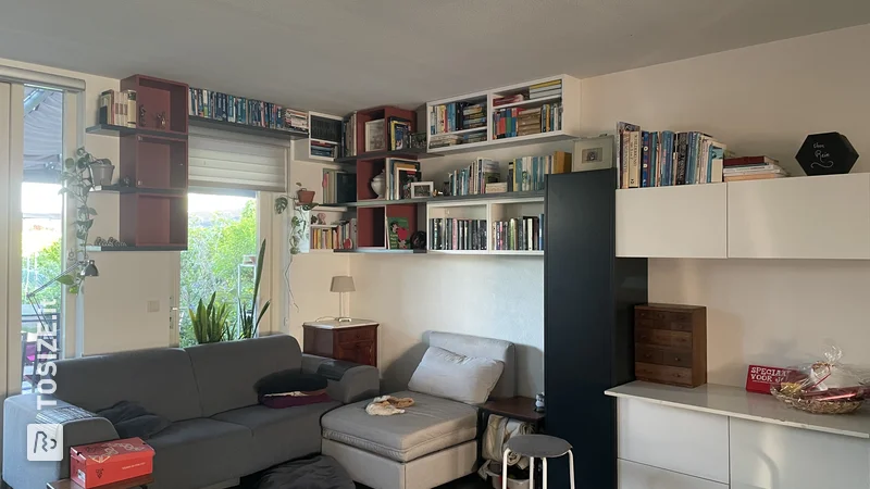 Una parete attrezzata personalizzata unica, realizzata con mobili IKEA esistenti e pannelli MDF segati, di Anton