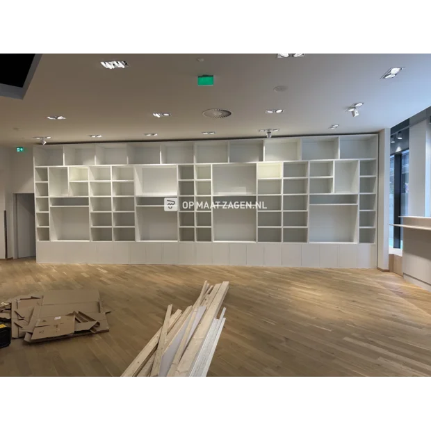 White cupboard wall with open compartments and doors